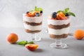Apricot trifle, chocolate biscuit, layered dessert with fresh berry and gentle cream cheese on grey Royalty Free Stock Photo