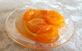 Apricot yellow jam in transparent saucer, photo color