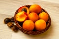 Apricots in a basket and a few apricot kernels net Royalty Free Stock Photo