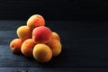 Apricots on black wooden background Royalty Free Stock Photo