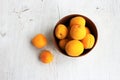 Apricots in a clay bowl on a white wooden background. Still life in a rustic style. Royalty Free Stock Photo