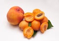 Apricots with green leaves and peach on a white background. Royalty Free Stock Photo