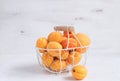 Apricots and peaches in metal basket Summer fruit concept Harvesting Organic fruits White background Copy space Royalty Free Stock Photo
