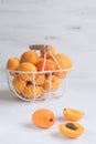 Apricots and peaches in metal basket Summer fruit concept Harvesting Organic fruits White background Copy space Royalty Free Stock Photo