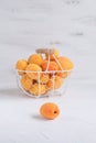 Apricots and peaches in metal basket Summer fruit concept Harvesting Organic fruits White background Copy space Royalty Free Stock Photo