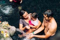 23 April, 2016, Bali, Indonesia - family at the holy spring water is waiting for praying at Pura Tirtha Empul