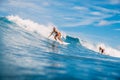 April 04, 2021. Bali, Indonesia. Sporty young woman in tropical ocean during surfing. Surfer girl on surfboard and perfect wave