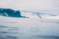 April 04, 2021. Bali, Indonesia. Sporty young woman in tropical ocean during surfing. Surfer girl on surfboard and perfect wave