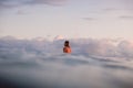 April 16, 2020. Bali, Indonesia. Surf girl relax on surfboard. Surfers in ocean during surfing.