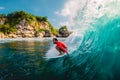 April 18, 2019. Bali, Indonesia. Surfer ride on barrel wave. Professional surfing at big waves in Padang Padang Royalty Free Stock Photo