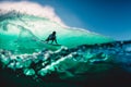 April 18, 2019. Bali, Indonesia. Surfer ride on barrel wave. Professional surfing at big waves in Padang Padang Royalty Free Stock Photo