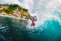 April 18, 2019. Bali, Indonesia. Surfer ride on barrel wave. Professional surfing at big waves in Padang Padang Royalty Free Stock Photo