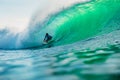 April 25, 2019. Bali, Indonesia. Surfer ride on barrel wave. Professional surfing with ideal ocean waves at Bingin beach