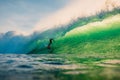 April 23, 2018. Bali, Indonesia. Surfer ride on big barrel wave at Padang Padang. Professional surfing in ocean Royalty Free Stock Photo