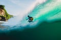 April 23, 2018. Bali, Indonesia. Surfer ride on big barrel wave at Padang Padang. Professional surfing in ocean Royalty Free Stock Photo