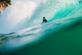 April 23, 2018. Bali, Indonesia. Surfer ride on big barrel wave at Padang Padang. Professional surfing in ocean Royalty Free Stock Photo