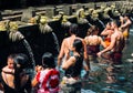 23 April, 2016, Bali, Indonesia - woman at the holy spring water is praying at Pura Tirtha Empul temple