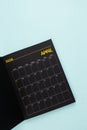 April 2026 Black calendar opening on blue background Royalty Free Stock Photo