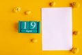 April 19. Blue cube calendar with month date and white mockup blank on yellow background. Royalty Free Stock Photo