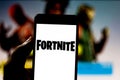 April 1, 2019, Brazil. Fortnite logo on the screen of the mobile device. Fortnite is an online multiplayer online game developed Royalty Free Stock Photo