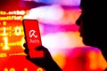 April 27, 2022, Brazil. In this photo illustration, a silhouetted woman holds a smartphone with the Avira AntiVirus logo displayed