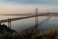 `25 of April` Bridge over tagus river at sunset in Lisbon, Portugal. View from Sanctuary of Christ the King `Cristo Rei Royalty Free Stock Photo