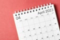 A April 2023 calendar desk for the organizer to plan and reminder isolated on red background