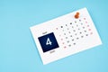 April 2024 calendar page with push pin on blue background Royalty Free Stock Photo