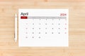 April 2024 calendar page on wooden