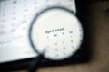 April 2020 Calender under magnifying glass. Royalty Free Stock Photo