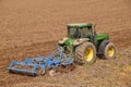 A farmer with a tractor plowing the land before sowing 071 Royalty Free Stock Photo