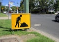 Yellow sign board of working man to caution drivers