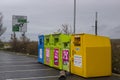 Colourful steel clothing banks for charities located in the local Tesco Extra car park at Newtownards County Down Northern Ireland