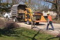 City workers use a wood chipper to conduct brush pickup, a service provided by the city.