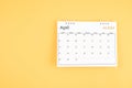 April 2024 desk calendar on yellow color background, position with copy space