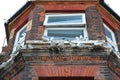 14 April 2023 - England, UK: Seagulls nesting on windowsill of old house