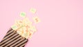 April Fools ' Day celebration background. Paper bag with many paper sheets with the words haha. 1 April mockup on pink background. Royalty Free Stock Photo