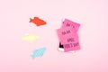 April Fools ' Day celebration background with paper fish, Smartphone and sticky note on pink background. All Fools ' Day, humor, Royalty Free Stock Photo