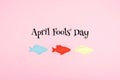 April Fools ` Day celebration background with paper fish and text on pink background. All Fools ` Day, humor, prank, joke concept