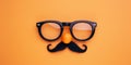 April Fools Day Disguise Topdown View Of Glasses, Fake Nose, And Mustache On Orange Backdrop Royalty Free Stock Photo