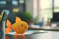 1 april fools day. Funny day. April fish. Prank. A plush goldfish toy sits on a desk, infusing a touch of whimsy into Royalty Free Stock Photo