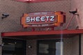 Sheetz electric neon sign above entrance on building