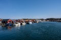 A picturesque fishing village on the Swedish West coast. Traditional red sea huts and a blue sky in the background
