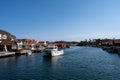 A picturesque fishing village on the Swedish West coast. Traditional red sea huts and a blue sky in the background