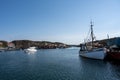 A picturesque fishing village on the Swedish West coast. Traditional red sea huts and a blue sky in the background