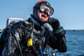 A closeup picture of a scuba diver waiting for the dive boat to get into position so he can enter the water. Ocean and