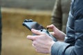 10 April 2022 - Krakow, Poland: Pilot holds the remote controller of Drone DJI in hands and remotely controls drone