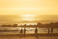 19 April 2023 Lisbon, Portugal: Costa da Caparica - young men playing ball on the beach at sunset Royalty Free Stock Photo