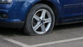 2 April 2022 - London, UK: Blue Ford car with flat tyre Royalty Free Stock Photo