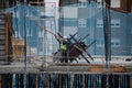 April, 15 2020, in Madrid, Spain a worker carries a heavy wooden slat in a building. Always protected with a mask from the covid